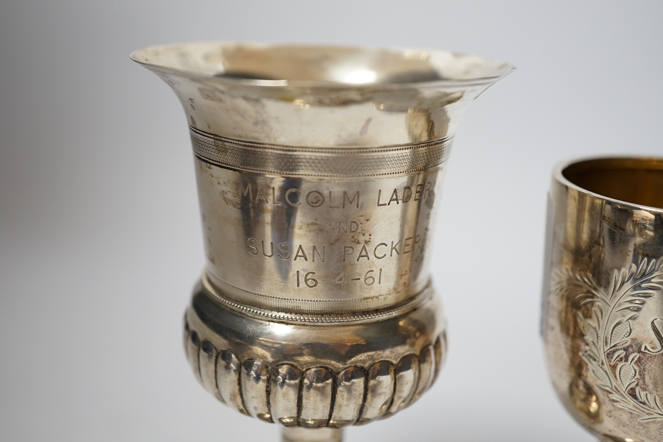 A small modern silver goblet, 11.2cm. and one other larger white metal goblet.